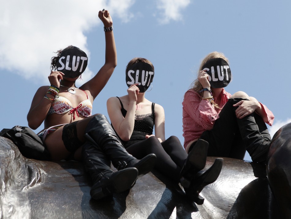 117269-women-sit-on-a-lion-in-trafalgar-square-during-a-rally-after-slutwalk-